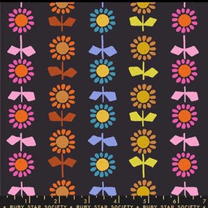 May include: A repeating pattern of stylized flowers and bow-tie shapes in pink, orange, yellow, and blue on a dark gray background. The flowers have a central circle and petals, while the bow-tie shapes are positioned between the flowers. The text "RUBY STAR SOCIETY" is at the bottom.