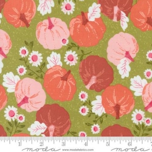 May include: A green fabric with a repeating pattern of pink, orange, and brown pumpkins with white flowers and leaves.