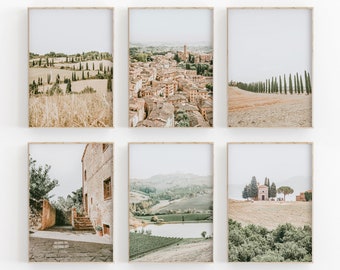 May include: Set of six framed prints featuring scenic views of Italian countryside. The prints showcase rolling hills, vineyards, a small town, and a church. The frames are a light wood color.