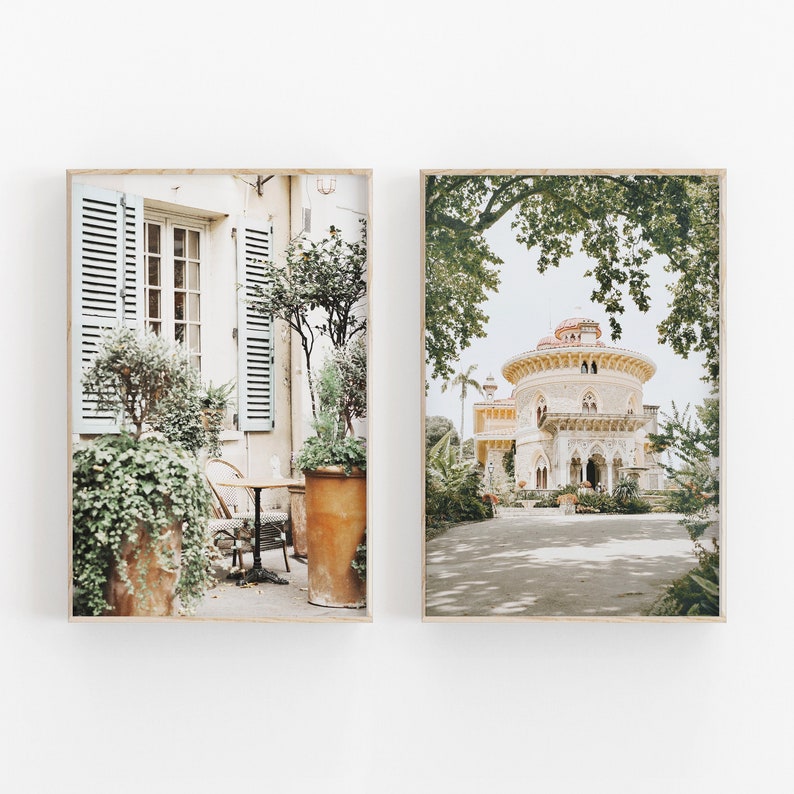 May include: Two framed prints of a European-style building. The left print shows a building with a cafe patio with a table and chairs. The right print shows a building with a dome roof and a garden.