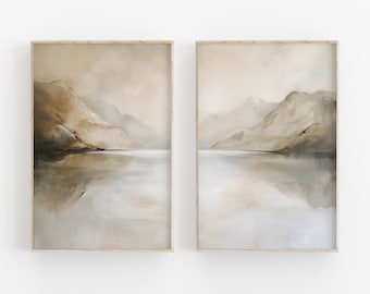 May include: A set of two framed abstract landscape paintings. The paintings feature a muted color palette of browns, tans, and grays. The paintings depict a mountain range reflected in a still body of water.