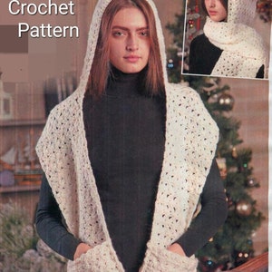 May include: A cream-coloured crocheted hooded scarf with two front pockets. The scarf is worn over a black turtleneck. The image includes the text "Crochet Pattern". A smaller image shows the scarf being worn.