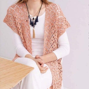May include: A crochet pattern for a peach-colored fringed cardigan with a white background. The pattern is available as a PDF in English (US).