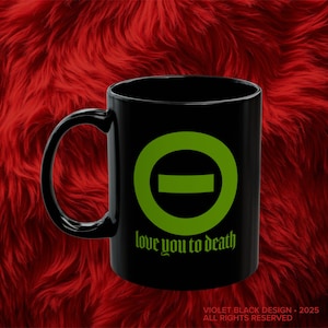 May include: Black ceramic mug with a green circle and a horizontal line inside. The text "love you to death" is printed below the circle.
