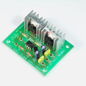 May include: A green circuit board with electronic components, including resistors, capacitors, and integrated circuits. The board is labelled "Single Supply to Dual Supply Converter" and "PK-5015".