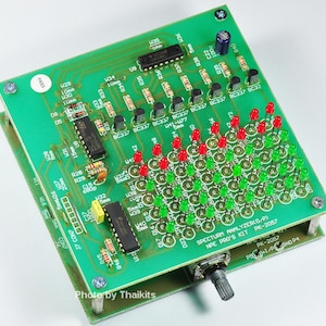May include: A green circuit board with a grid of red and green LEDs, a potentiometer, and text that reads "SPECTRUM ANALYZER(O/P) NPE PRO'S KIT PK-2057".