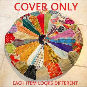 May include: A round, multi-colored patchwork cushion cover with a circular design in the center. The cover is made of various fabrics and colors, including red, green, blue, yellow, and purple. "COVER ONLY" is written in red at the top of the image. "EACH ITEM LOOKS DIFFERENT" is written in red at the bottom of the image.