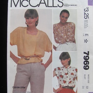 May include: A sewing pattern for a women's blouse with a square neckline and short sleeves. The pattern is from McCall's and is for size 12, bust 34. The pattern is called "Carole Little for Saint-Tropez West" and is for tops only.