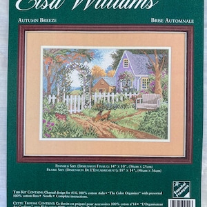 May include: A framed Elsa Williams counted cross stitch kit. The artwork shows an autumn scene with a purple house, white picket fence, and a path. Finished size is 36cm x 25cm. The kit includes charted design, cotton floss, and needle. Frame size is 46cm x 36cm.