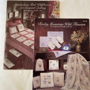 May include: Two vintage books with floral designs. The top book is titled "Appalachian Trail Wildflowers for Counted Quilting." The bottom book is titled "Rocky Mountain Wild Flowers." Both books feature images of quilts and embroidery.