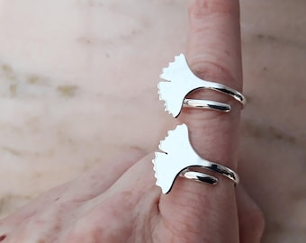 May include: Two silver rings shaped like ginkgo leaves. The rings are adjustable and can be worn on any finger.