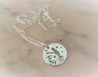 May include: Silver necklace with a round pendant featuring a cutout of a fairy with stars and the name "Maël" inscribed.