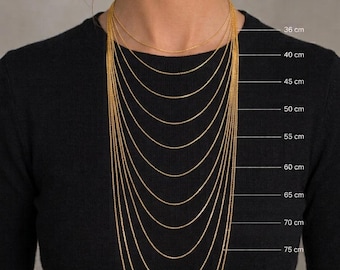 May include: A collection of gold-toned chains displayed in varying lengths from 36 cm to 90 cm. Each chain is layered to demonstrate the different drop lengths, with labels indicating the specific metric measurements for each individual chain.