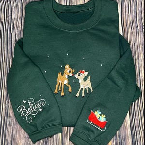 Rudolph Christmas Embroidered T-Shirt, Rudolph and Clarice Embroidery Christmas Sweater, Red Nose Reindeer Hoodie, Believe Christmas Gift