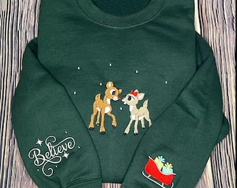 Rudolph Christmas Embroidered T-Shirt, Rudolph and Clarice Embroidery Christmas Sweater, Red Nose Reindeer Hoodie, Believe Christmas Gift