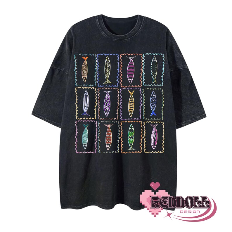 May include: Black t-shirt with a colorful fish design. The fish are arranged in a grid pattern and are outlined in white. The shirt has a distressed look.