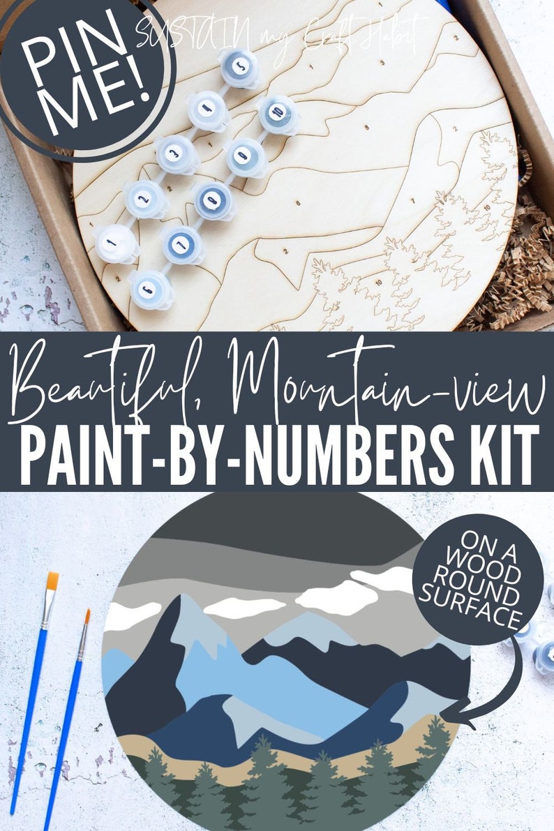 Peut inclure: Un kit de peinture par num&eacute;ros repr&eacute;sentant un paysage de montagne avec des couleurs bleues, grises et vertes. Le kit comprend une surface ronde en bois, des pots de peinture et des pinceaux. Le texte "PIN ME!" et "Beautiful, Mountain-view PAINT-BY-NUMBERS KIT" est visible sur l'image. Le texte "ON A WOOD ROUND SURFACE" est &eacute;galement visible.
