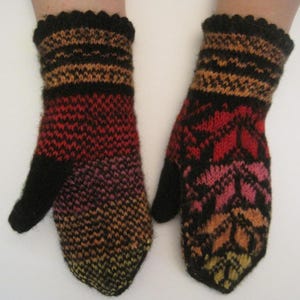 May include: A pair of knitted mittens featuring a multi-colored gradient pattern in shades of red, orange, pink, and yellow against a black background. The mittens have solid black thumbs and a scalloped black edge at the wrist opening.