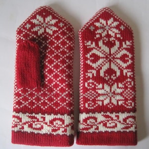 May include: Pair of red and white knitted mittens with a snowflake pattern. The mittens have a thumb hole and a separate finger compartment.