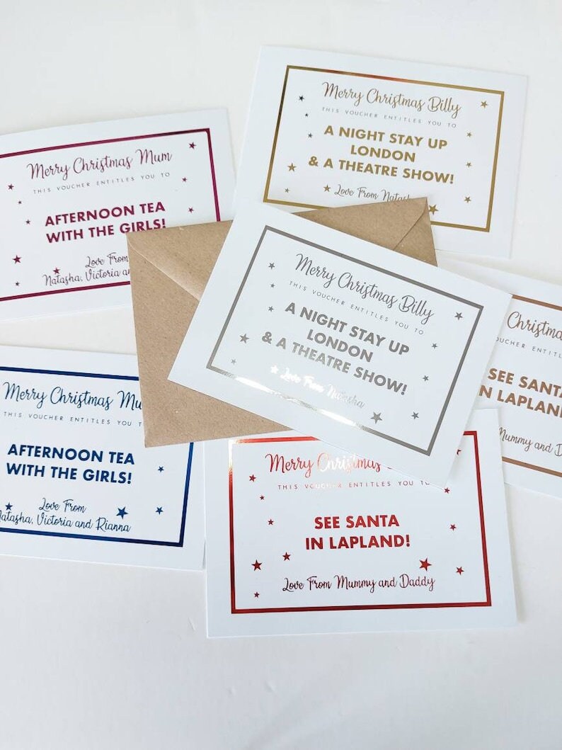 May include: Four Christmas gift vouchers with gold, silver, and red foil accents. The vouchers are for a night stay in London and a theatre show, afternoon tea with the girls, seeing Santa in Lapland, and a night stay in London and a theatre show.