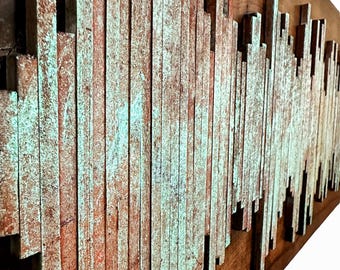May include: A wall art piece made of wooden slats, painted in shades of brown, green, and white. The slats are arranged in a wave-like pattern, creating a textured and abstract design.