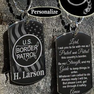 May include: A silver necklace or keychain with two black dog tags. The front tag features a black and white American flag with a circle that says "U.S. BORDER PATROL" and the name "H. Larson". The back tag has a prayer that says "Lord, I ask you to be with me as I Protect and Patrol this country's border. Be my Strength, and my Guide to keep things in order. Whatever I am called to do Always ready I will be, But please Lord, get me through it safely. Amen."