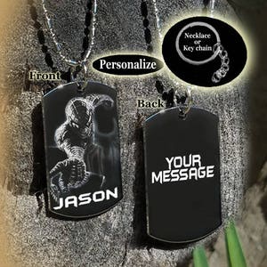 May include: Black metal dog tag necklace or keychain with a Spiderman image on the front and the name "JASON" engraved below. The back of the tag has the text "YOUR MESSAGE" engraved in white.