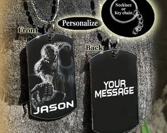 May include: Black metal dog tag necklace or keychain with a Spiderman image on the front and the name "JASON" engraved below. The back of the tag has the text "YOUR MESSAGE" engraved in white.