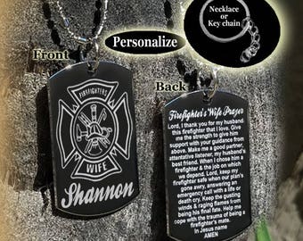 May include: A black metal dog tag necklace with a firefighter's cross and the word "WIFE" on the front. The back of the tag has a prayer for a firefighter's wife. The tag is personalized with the name "Shannon".
