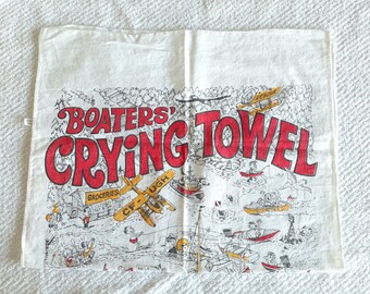 May include: White kitchen towel with a red and black illustration of a boat and the text "BOATERS' CRYING TOWEL".