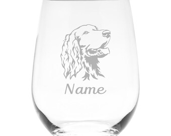 May include: A clear stemless wine glass featuring an etched illustration of a spaniel dog head in profile. Below the dog illustration, the word Name is etched in a cursive script font. The glass has a rounded body and a smooth, transparent finish.
