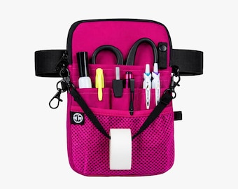 May include: A magenta-colored medical organizer bag with multiple pockets and compartments. The bag contains various medical tools, including scissors, pens, and a roll of tape. It has a black adjustable strap and a black clip.