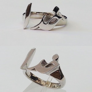 May include: Two silver rings with Arabic calligraphy. The rings are simple and elegant, with a smooth finish.