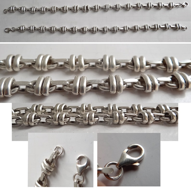 May include: Three silver chains with different link styles. The top two chains have a simple, round link design. The bottom chain has a more intricate, woven link design. All three chains have a lobster claw clasp.
