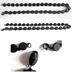 May include: A black necklace with round beads and a clasp. The necklace is made of metal and has a matte finish.