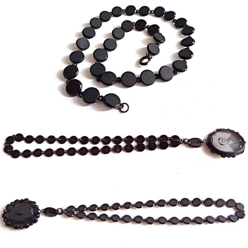 May include: Three black beaded necklaces, one with a locket featuring a black and white photo, and another with a large black button.