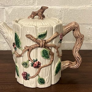 May include: A set of three ceramic mugs with a speckled, matte finish. The mugs are in shades of cream, light gray, and dark gray. Each mug has a simple, minimalist design, perfect for coffee or tea.