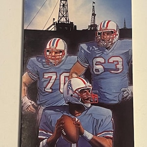 May include: Houston Oilers 1985 Media Guide. The cover features a painting of three football players in light blue jerseys and helmets with red and white accents. The background shows oil derricks and a blue sky.