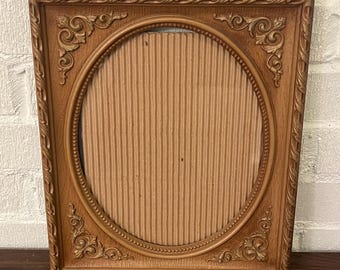 Vintage ornate brown & gold picture frame with glass oval design