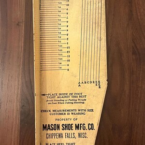 May include: Vintage foot measuring device from Mason Shoe Mfg. Co. in Chippewa Falls, Wisconsin. The device is made of cardboard and features a ruler with inch measurements, size indicators, and instructions for use. The text reads "Always measure the right foot."