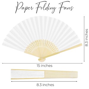May include: White paper folding fan, 15 inches wide and 8.3 inches high when open. The fan has a natural wood handle and the text "Paper Folding Fans" in a script font.