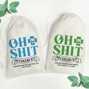 May include: Two off-white drawstring bags with the text "OH SHIT RECOVERY KIT". One bag has blue text and the other has green text. The bags are for bachelor parties in Vegas and Scottsdale, AZ.