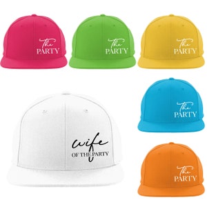 May include: Six different colored baseball caps with embroidered text. The caps are white, pink, green, yellow, blue, and orange. The text on the caps reads "The Party" and "Wife of the Party".