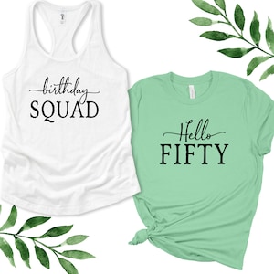 May include: Two shirts, one white tank top with the text "birthday SQUAD" and one green t-shirt with the text "Hello FIFTY".