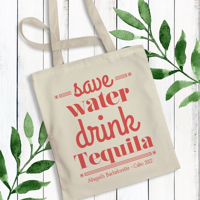 May include: A white canvas tote bag with red text that reads "save water drink tequila" and "Abagails Bachelorette - Cabo 2022".