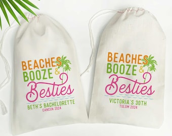May include: Two white drawstring bags with the text "Beaches Booze & Besties" printed on them. One bag says "Beth's Bachelorette Cancun 2024" and the other says "Victoria's 30th Tulum 2024".