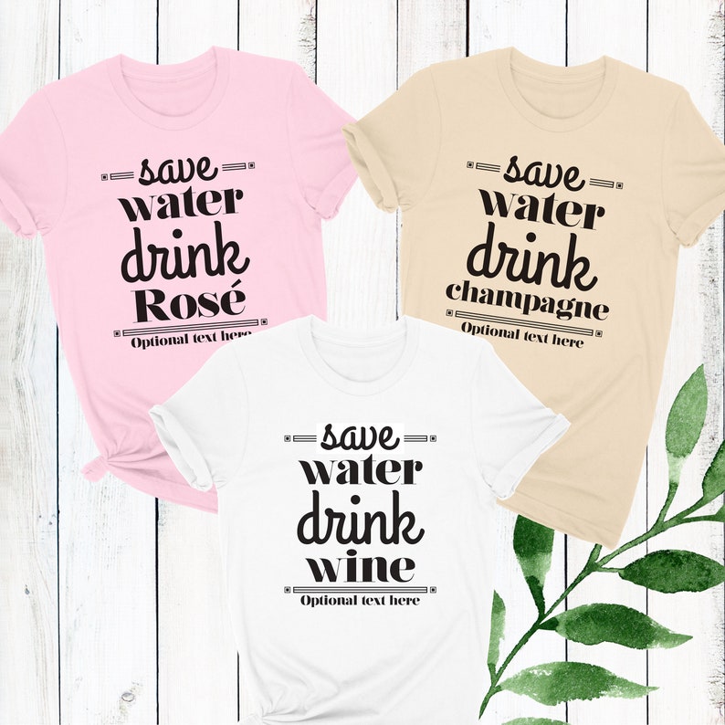 May include: Three t-shirts with the text "save water drink" and a different beverage on each shirt. The shirts are pink, beige, and white. The text is in black.