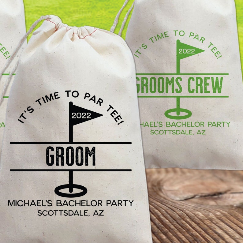 May include: White drawstring bag with a golf-themed design. It says "It's time to par tee!" with a golf flag and the year 2022. The bag also says "Groom" and "Michael's Bachelor Party Scottsdale, AZ".