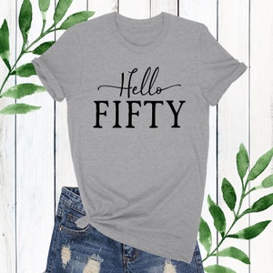May include: Gray t-shirt with black text that says "Hello Fifty".