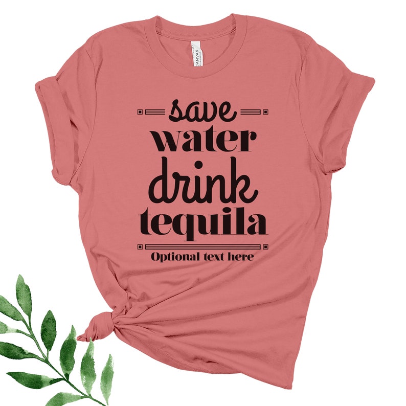May include: A pink t-shirt with the text "save water drink tequila" in black lettering. The text is in a stylized font. The shirt has a knotted front.